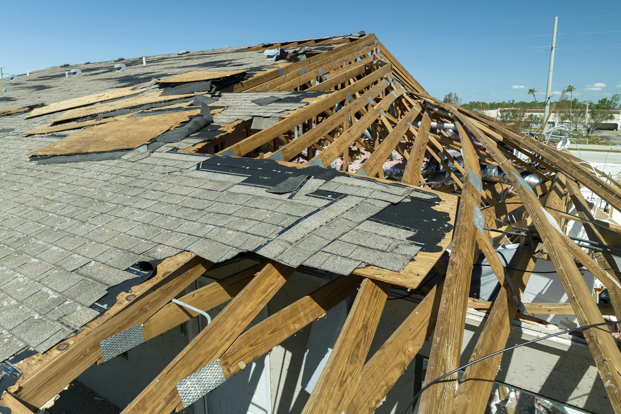 Roof damage with wooden beams exposed